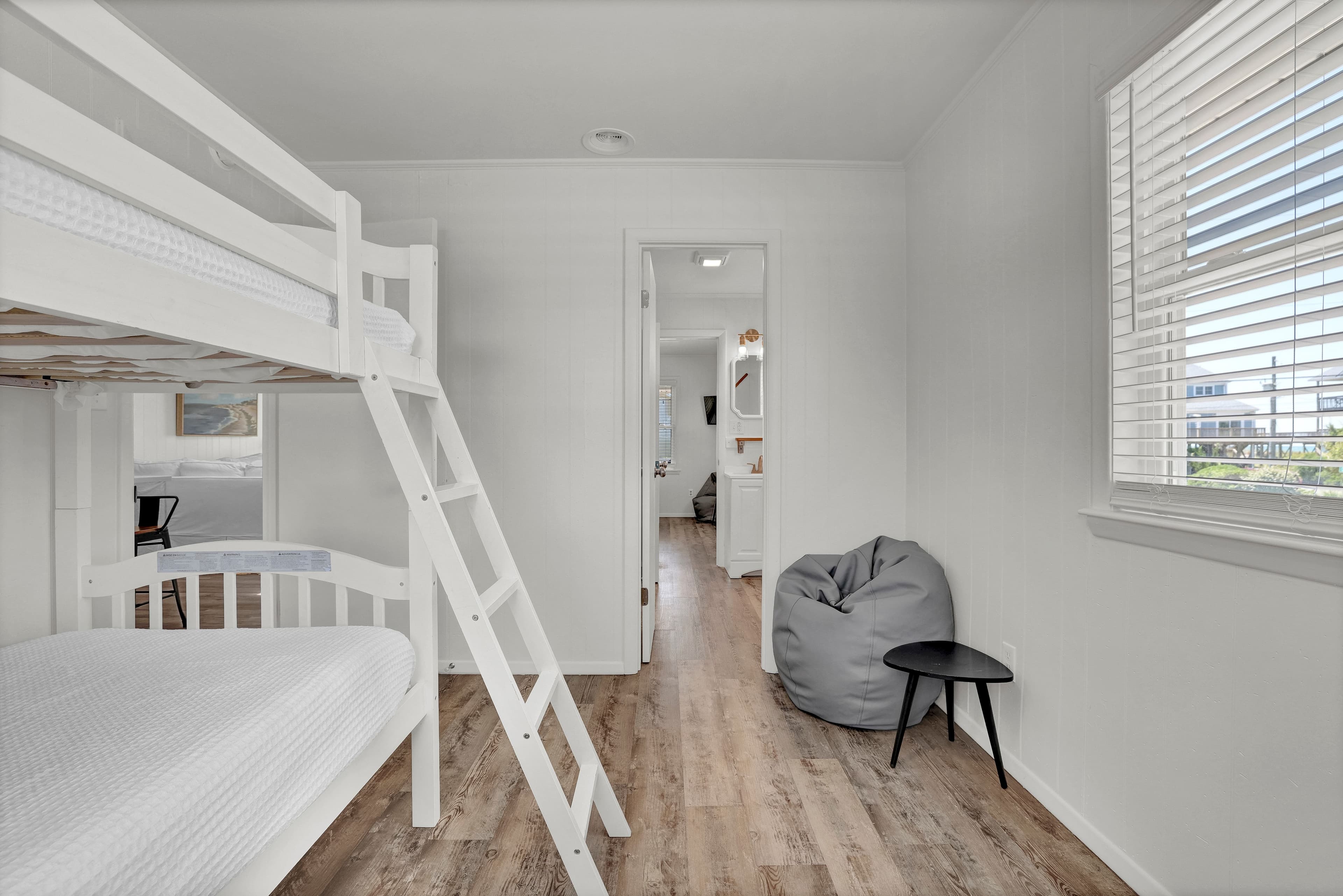Bright bunk room with natural light and cozy seating for extra guests