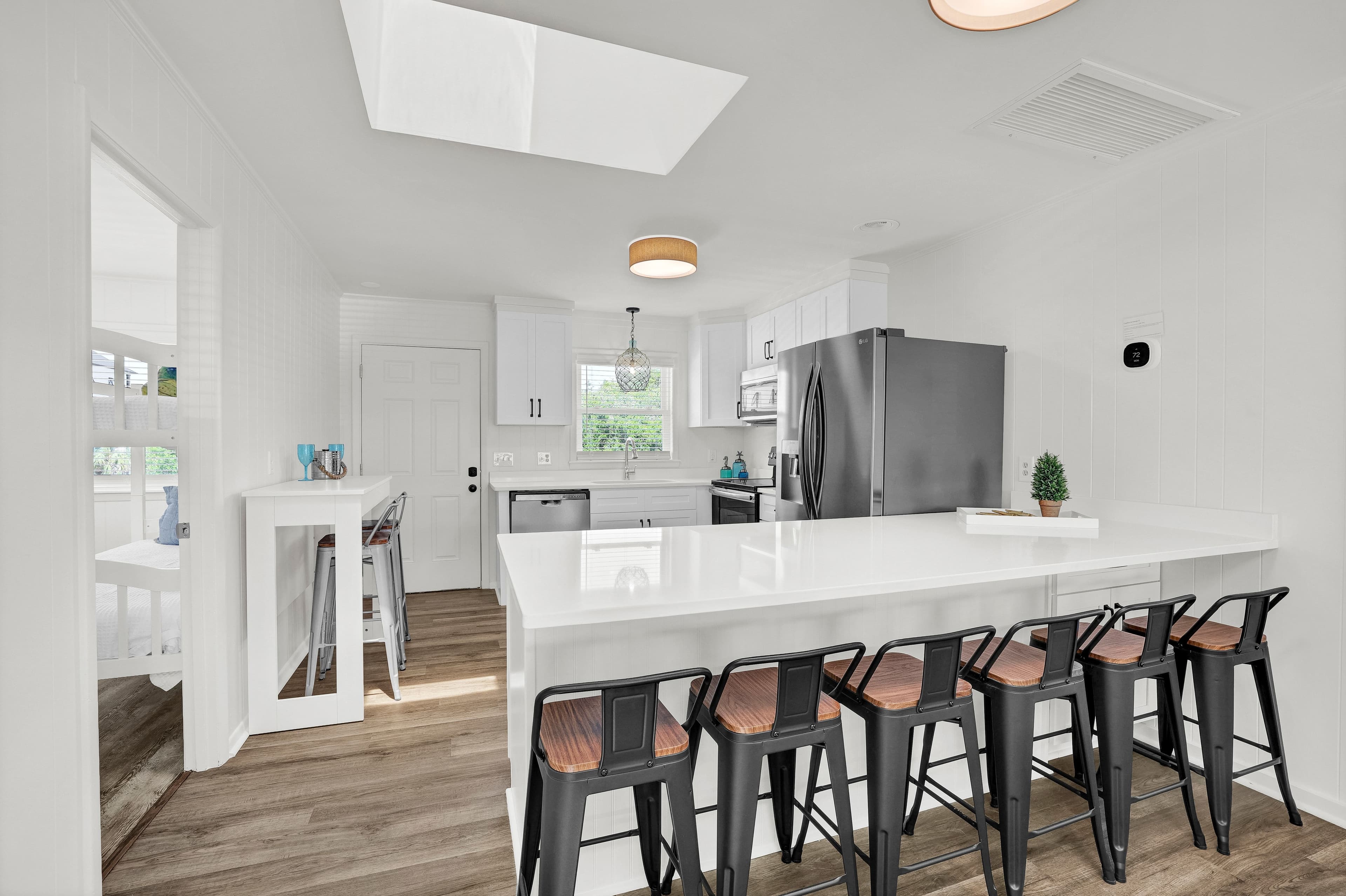 Bright modern kitchen with large island seating for 6 and skylight