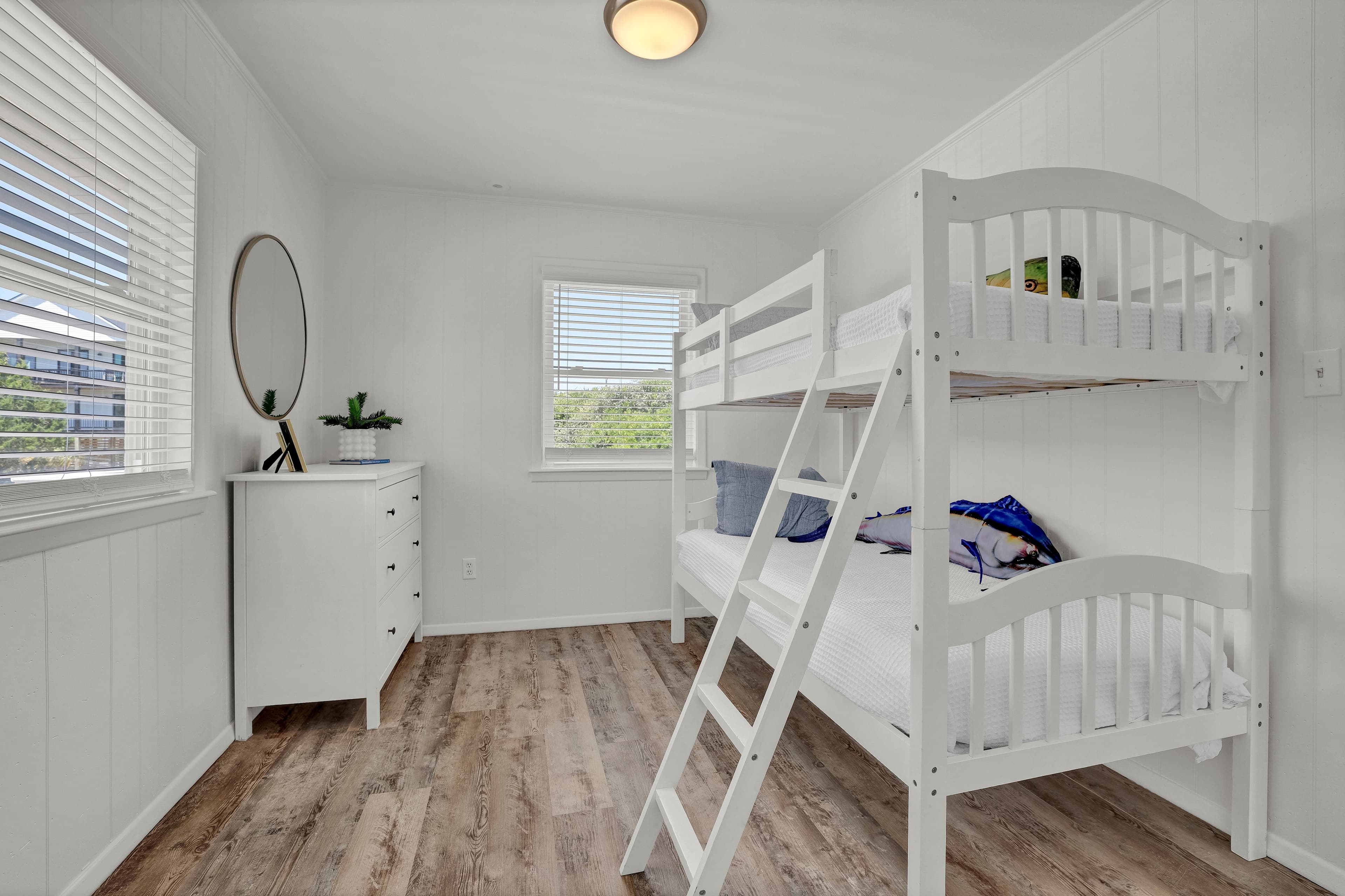 Bright bunk room with twin-over-twin beds and a fresh, airy feel