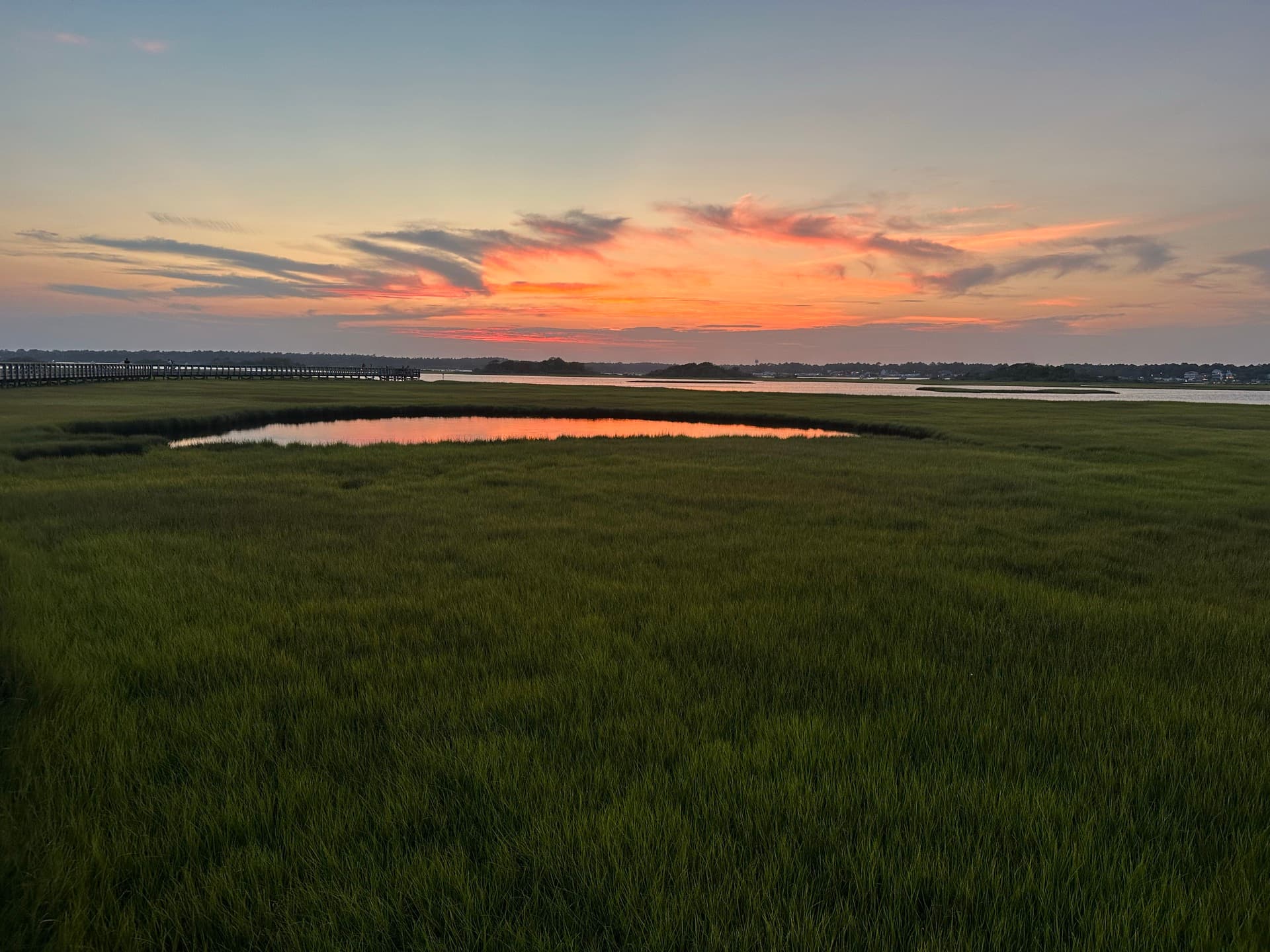 Topsail marsh at sunset with pink and orange clouds